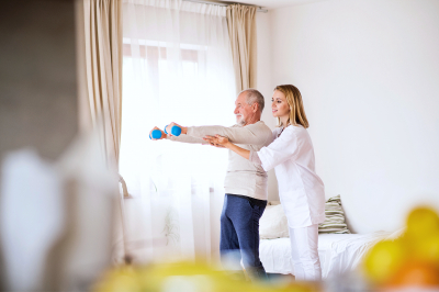 elder man doing regular exercise with his caregiver