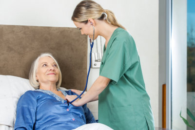 a nurse checking an erderly woman