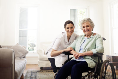 a caregiver smiling with an erderly woman