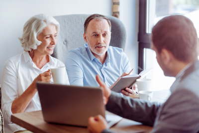 elder man and woman consulting with insurance agent